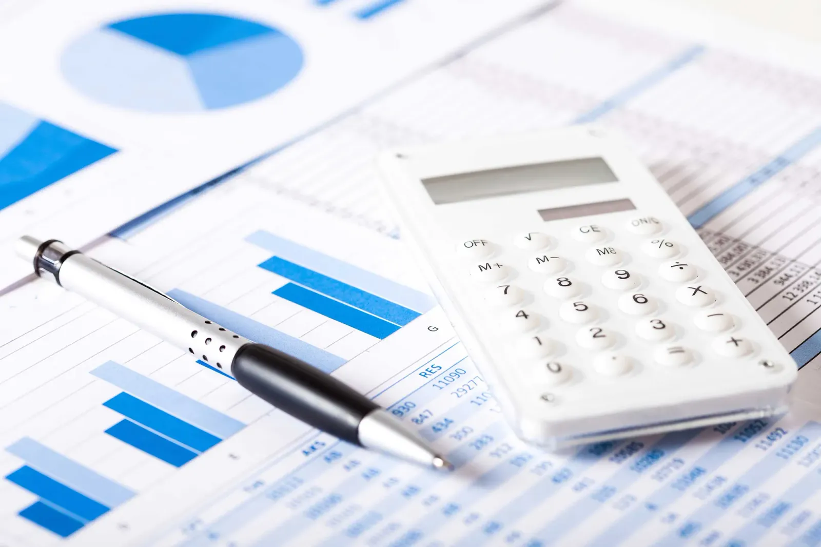 Financial charts and calculator on a desk